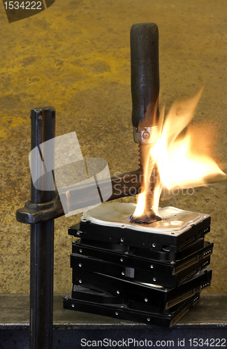Image of burning vise and hard disks