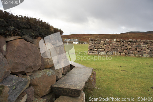 Image of idyllic bench and stone wall