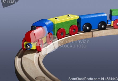 Image of colorful wooden toy train on tracks