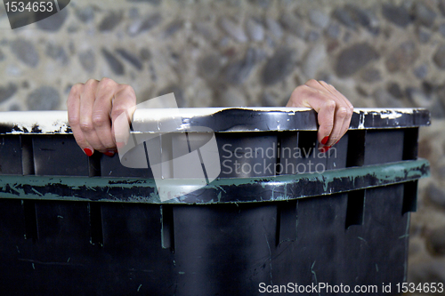 Image of Woman peeking out of a garbage