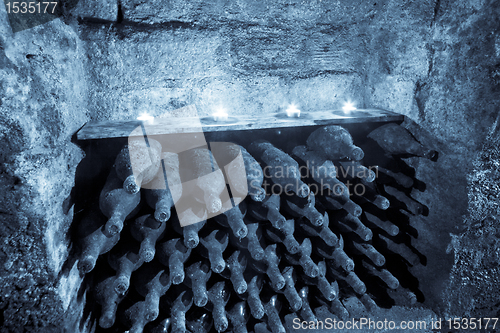 Image of wine bottles with candles