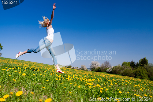 Image of happy young woman on meadow