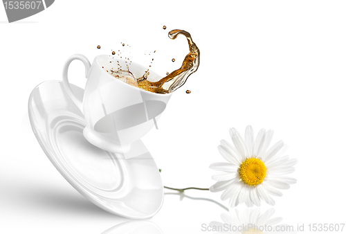 Image of Splash of tea in the falling cup with flower isolated on white 