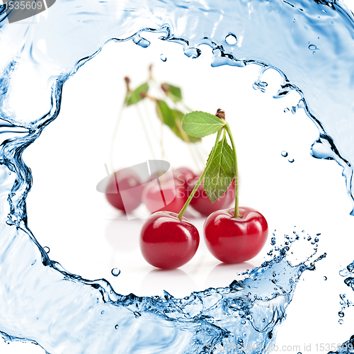 Image of Red cherry with leaves and water splash isolated on white