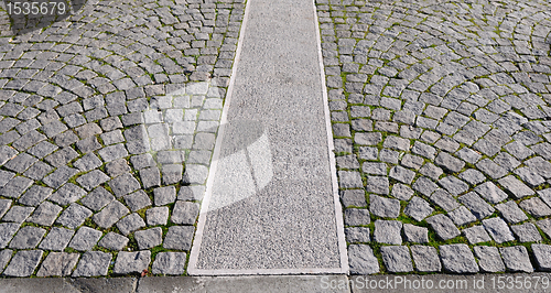 Image of Old grey pavement in a pattern in an old medieval european town.