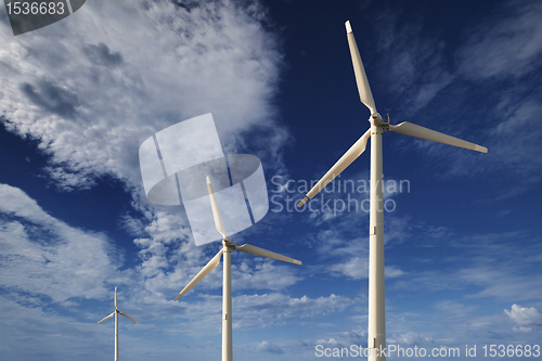 Image of Wind turbines against a blue sky