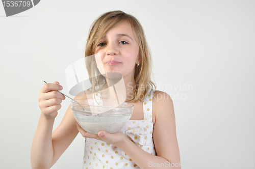 Image of child with a bowl of milk porridge