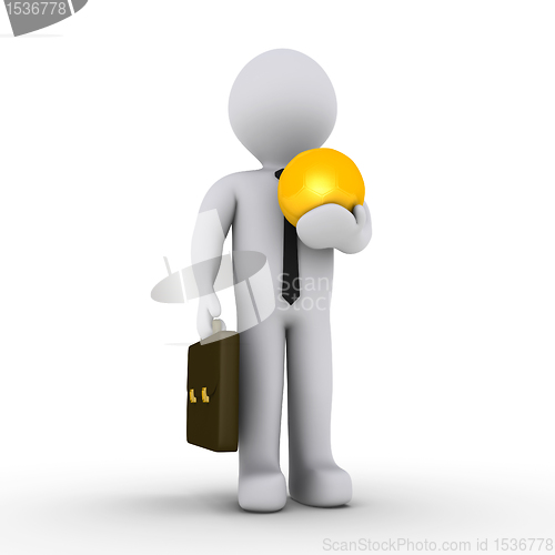 Image of Businessman holding golden soccer ball