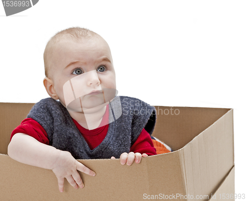 Image of young child in cardboard box