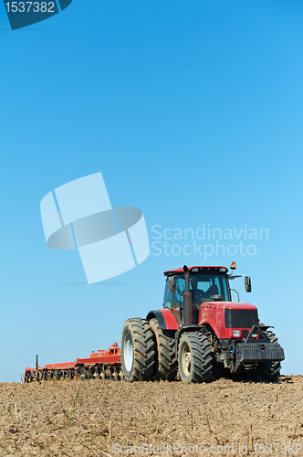 Image of Ploughing tractor at field cultivation work