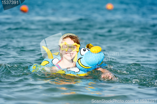 Image of little girl swimming in sea