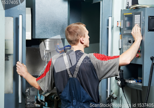 Image of worker at machining tool workshop