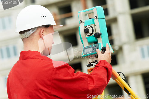 Image of surveyor works with theodolite