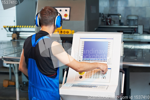 Image of worker operating cnc punch press