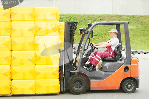 Image of worker driver at warehouse forklift loader works