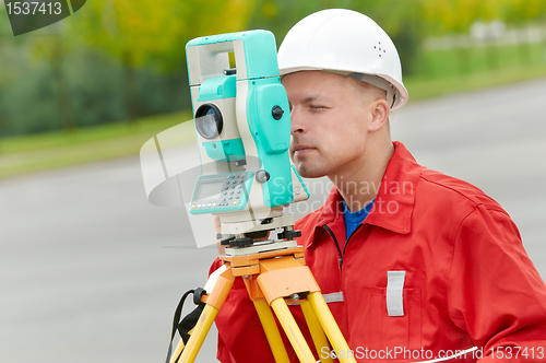 Image of surveyor works with theodolite