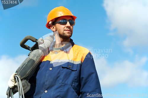 Image of portrait of construction worker with perforator