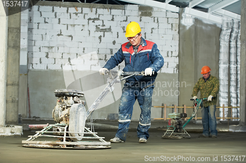 Image of Worker trowelling and finishing of concrete