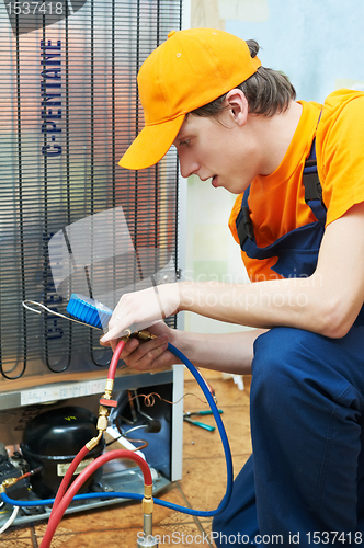 Image of repair work on fridge appliance