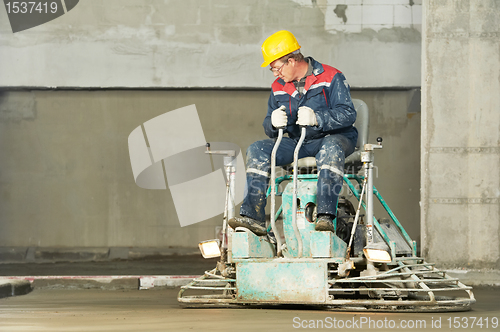 Image of Worker trowelling and finishing of concrete