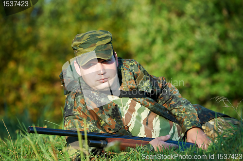 Image of hunter with rifle gun