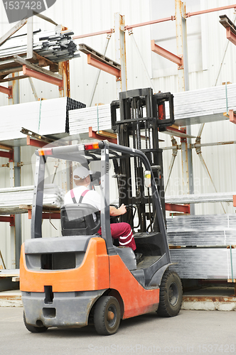 Image of worker driver at warehouse forklift loader works