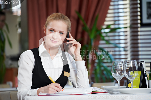 Image of restaurant manager woman at work place