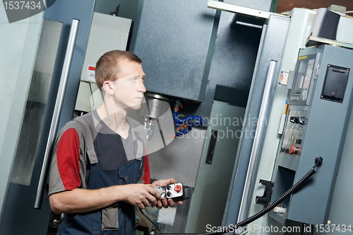 Image of worker at machining tool workshop