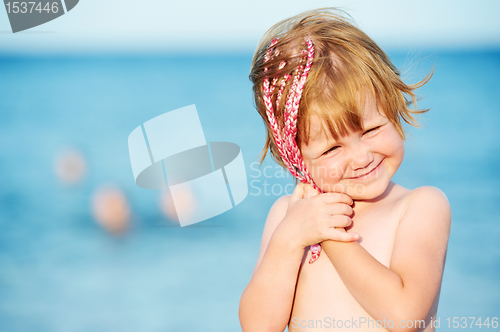 Image of little girl at sunset in front of red sea