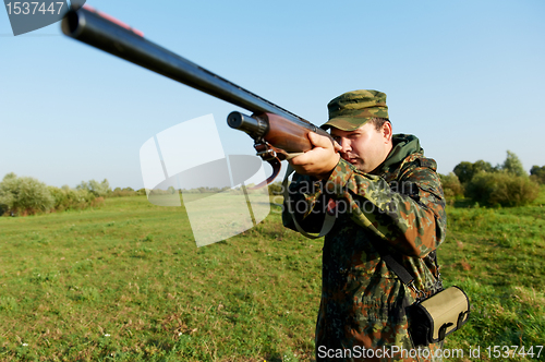 Image of hunter with rifle gun