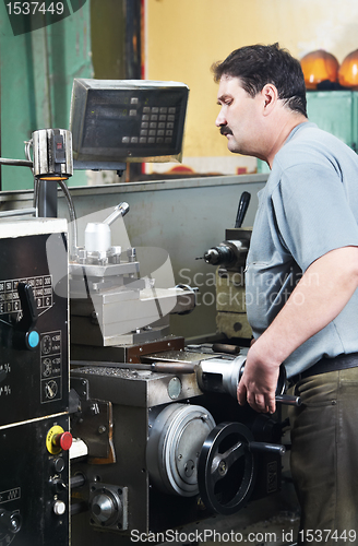 Image of worker at machining tool workshop