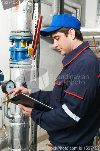 Image of heating engineer repairman in boiler room