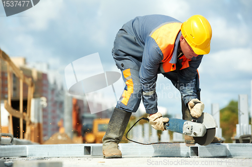 Image of builder working with cutting grinder