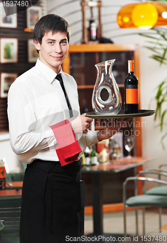 Image of waiter in uniform at restaurant