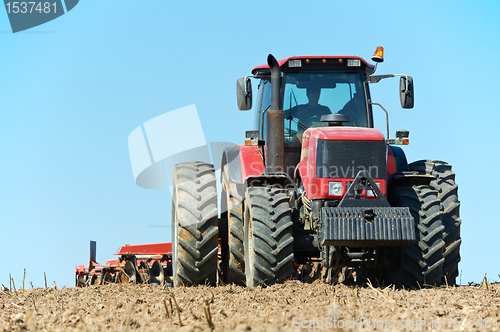 Image of Ploughing tractor at field cultivation work