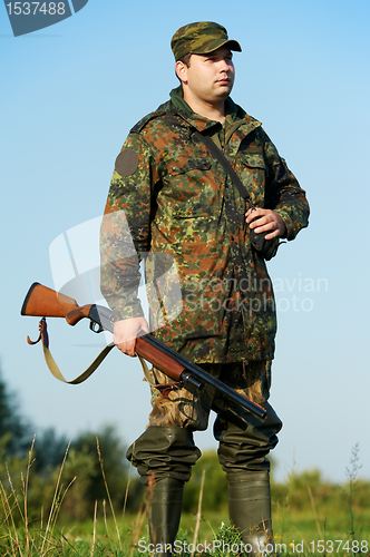 Image of hunter with rifle gun