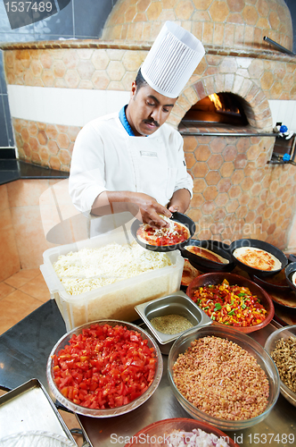 Image of Arab baker chef making Pizza