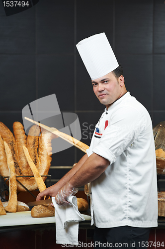 Image of Arab chef cutting bread