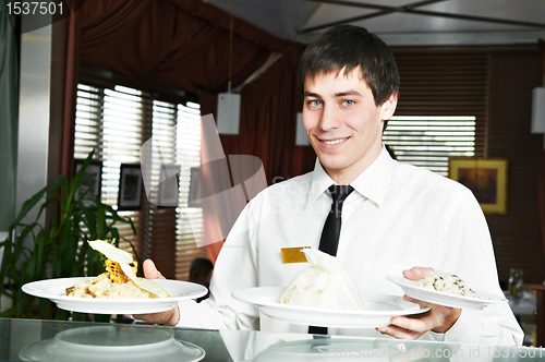 Image of waiter in uniform at restaurant