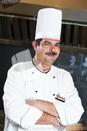 Image of chef in uniform at kitchen