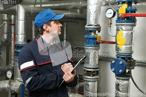 Image of heating engineer repairman in boiler room