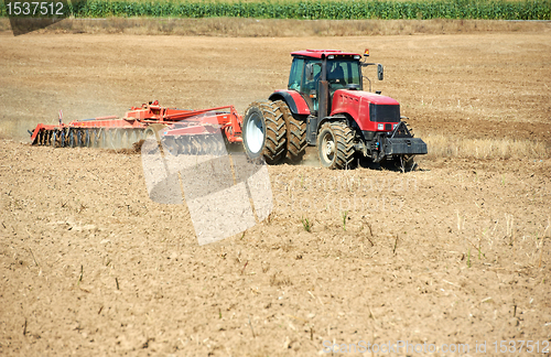 Image of Ploughing tractor at field cultivation work