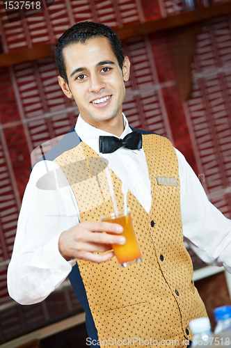 Image of Cheerful arab barman