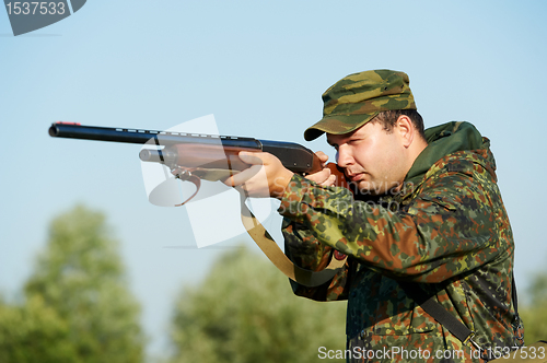 Image of hunter with rifle gun