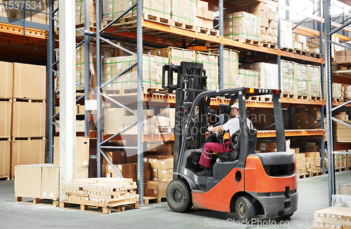 Image of worker driver at warehouse forklift loader works