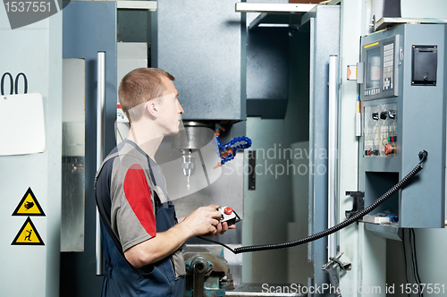 Image of worker at machining tool workshop