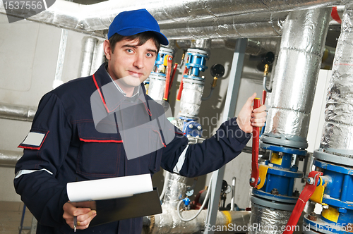 Image of heating engineer repairman in boiler room