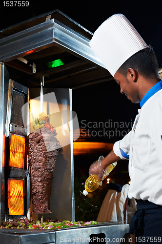 Image of Arab chef making kebab