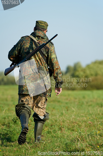 Image of hunter with rifle gun