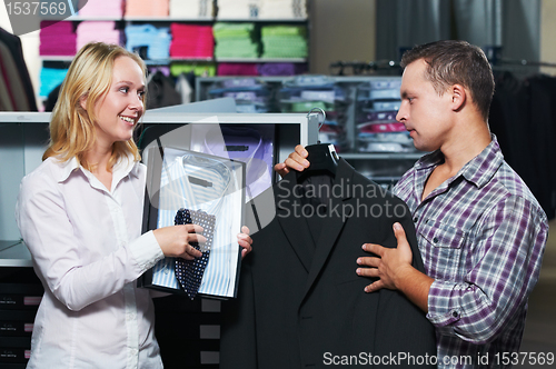 Image of Young couple at clothes shopping